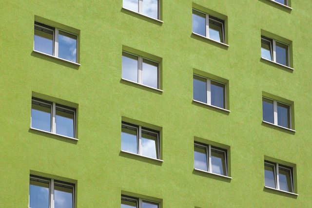 green building exterior , windows on house facade